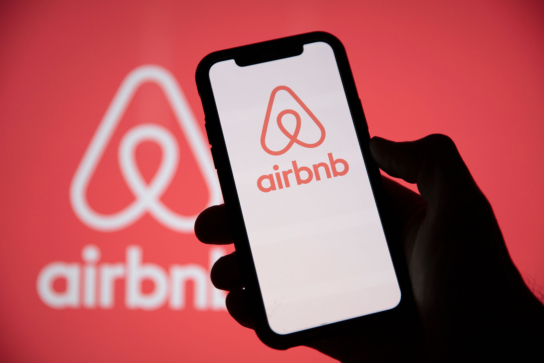 Airbnb logo on a smartphone screen