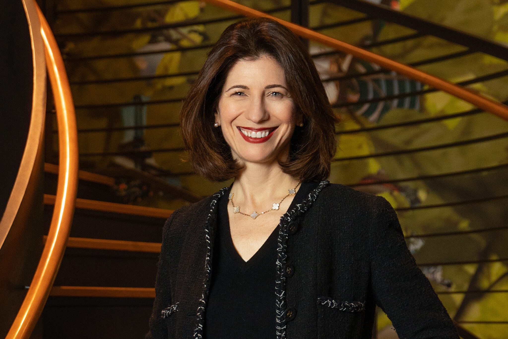 Expedia Group CEO Ariane Gorin standing on some steps inside a building.