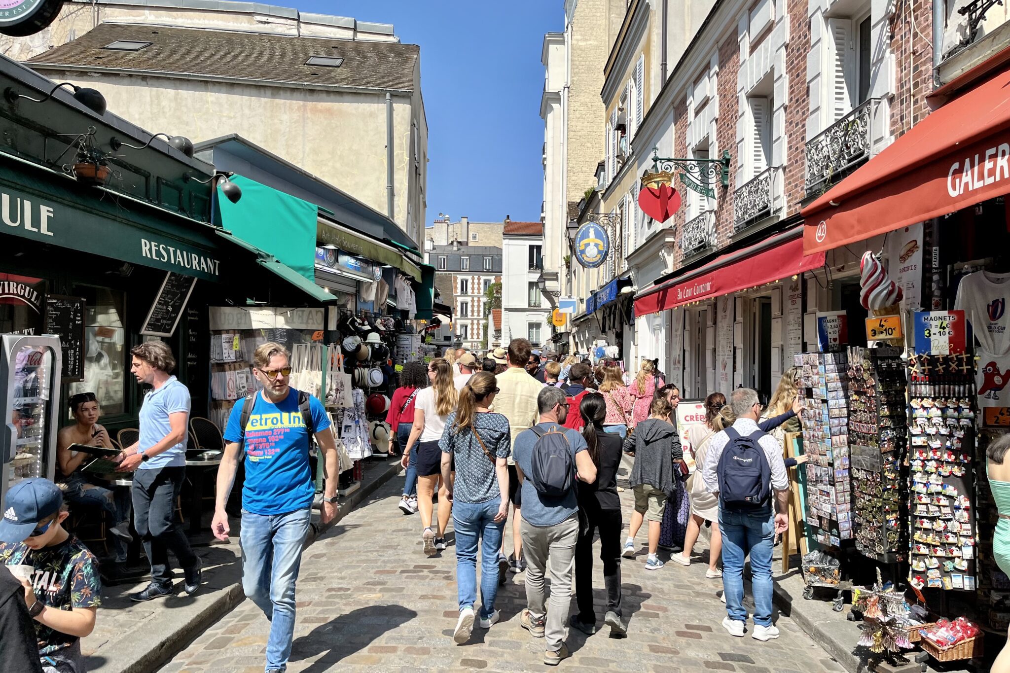 Paris tourists outside of shops selling trinkets.