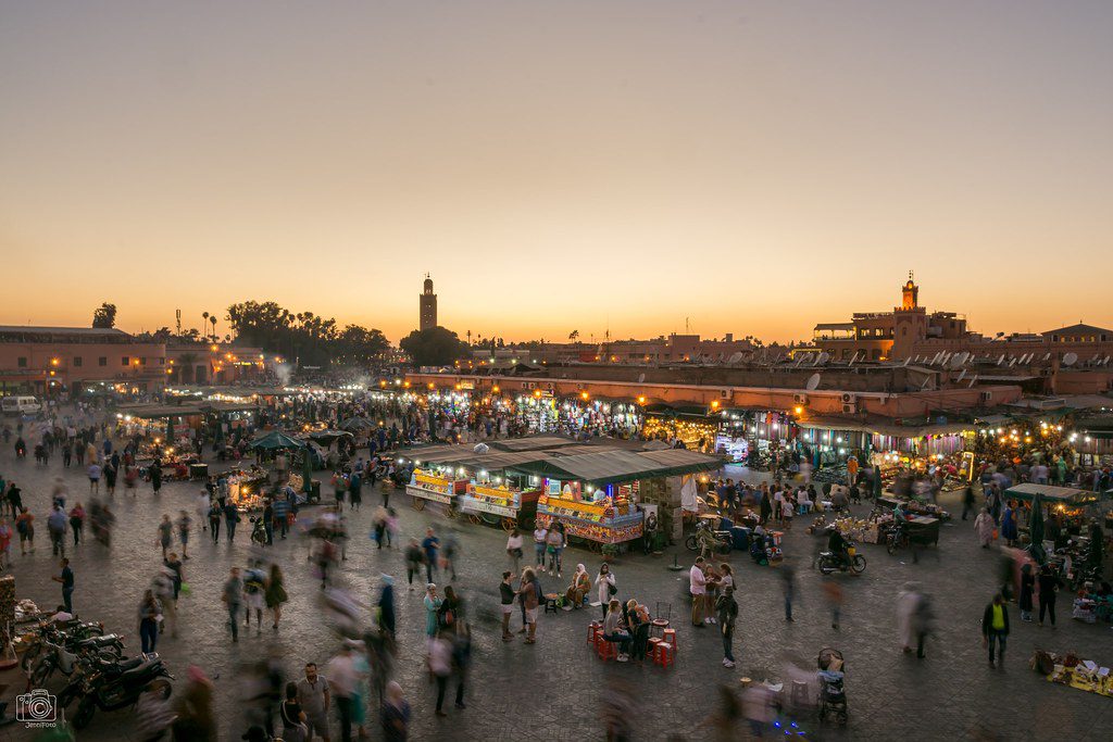 crowded jemma el-fna market square at dusk in marrakesh morocco