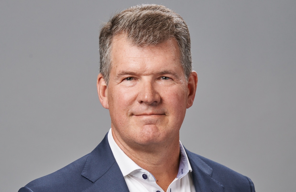 A headshot of a man in a sports jacket.