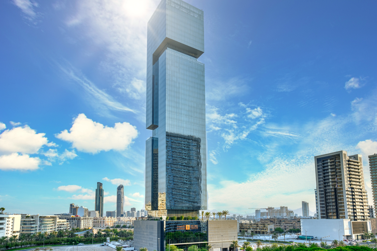 image of a skyscraper against a skyline in dubai on a bright blue day with the building containing a hotel