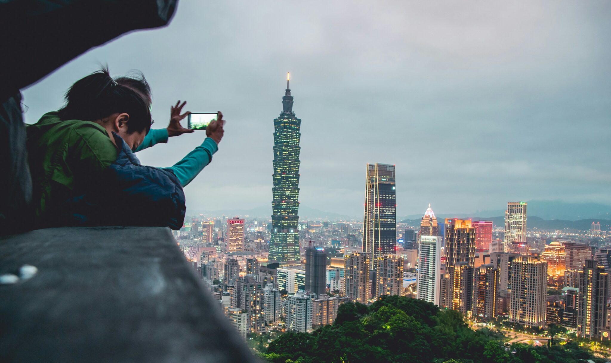 Visitors taking a photograph of Taipei's skyline