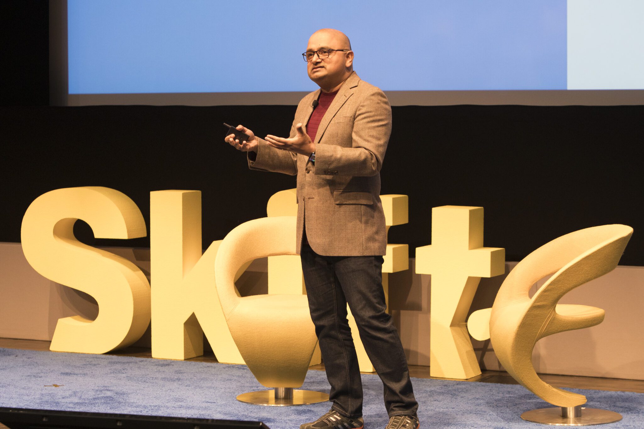 A man on stage speaking at the Skift Data + AI Summit.